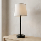 Black table lamp from a side angle in matching setting